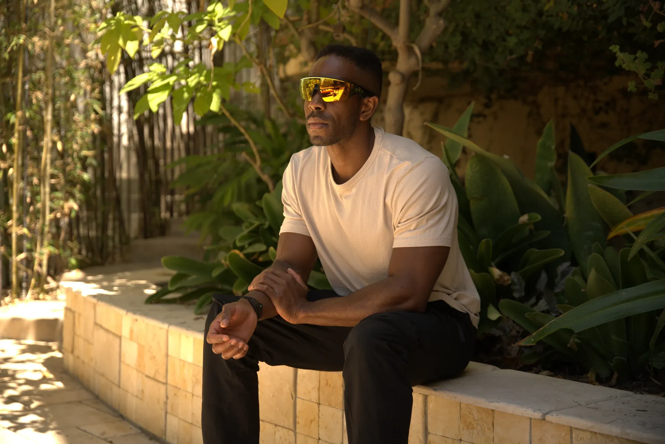 Person outdoors wearing AR smart glasses and a Tap band on the wrist.
