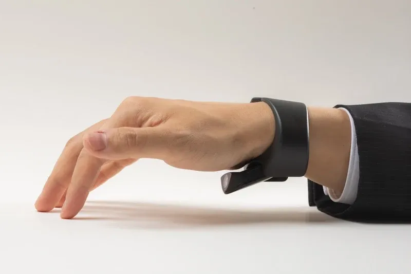 Tap XR wristband on a hand, mid-gesture.